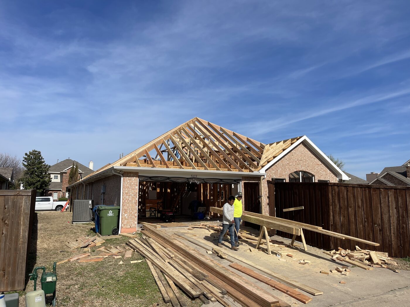 New roof framing going up on a lightning-damaged home in The Colony