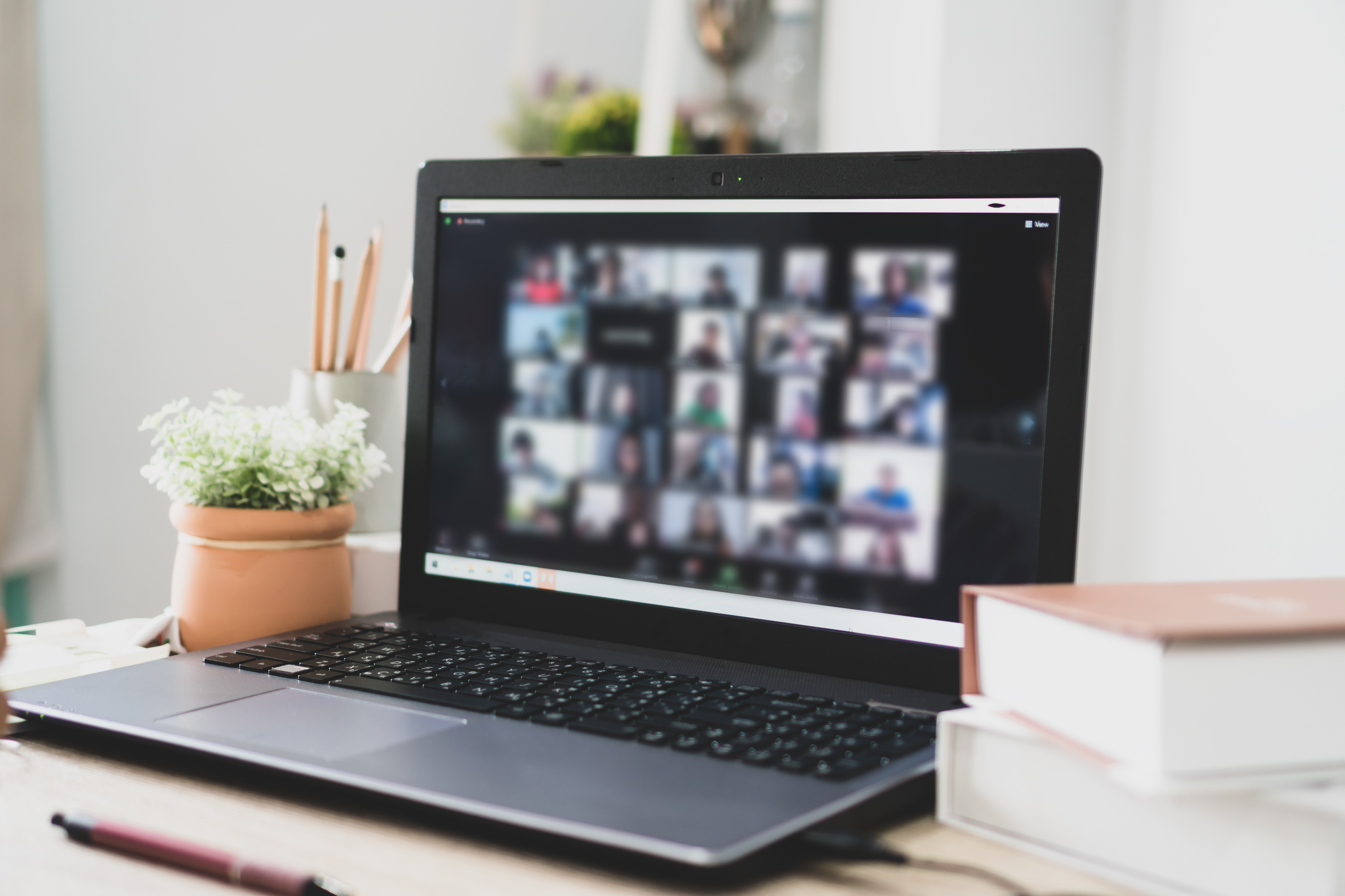 Laptop beside an online Zoom workshop for beauty professionals