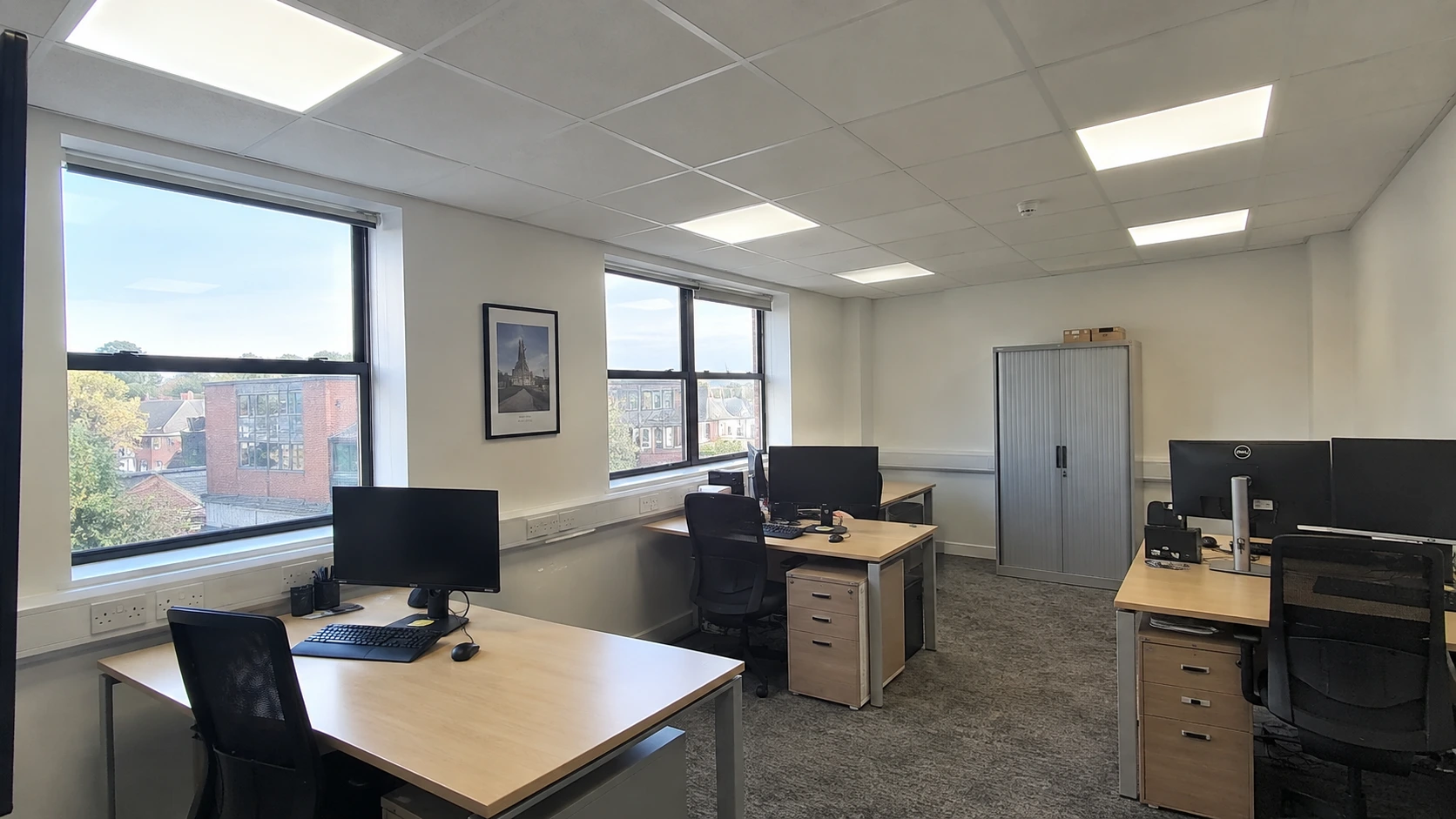 Ceiling lighting and perimeter power in a British office.