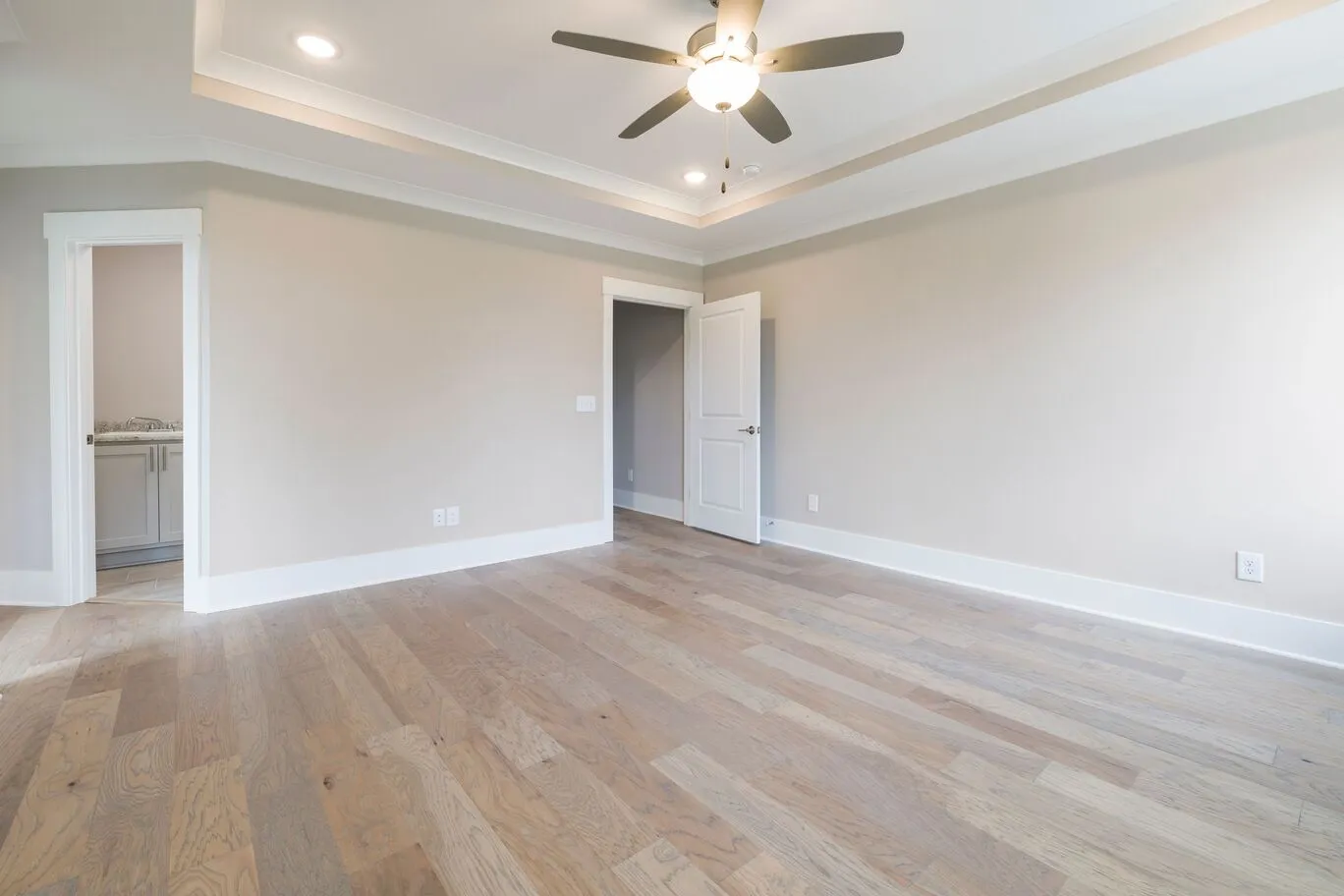 Newly renovated Kanata, Ontario living room featuring realistic luxury vinyl plank flooring with warm wood tones, clean plank lines, and a professionally finished installation.