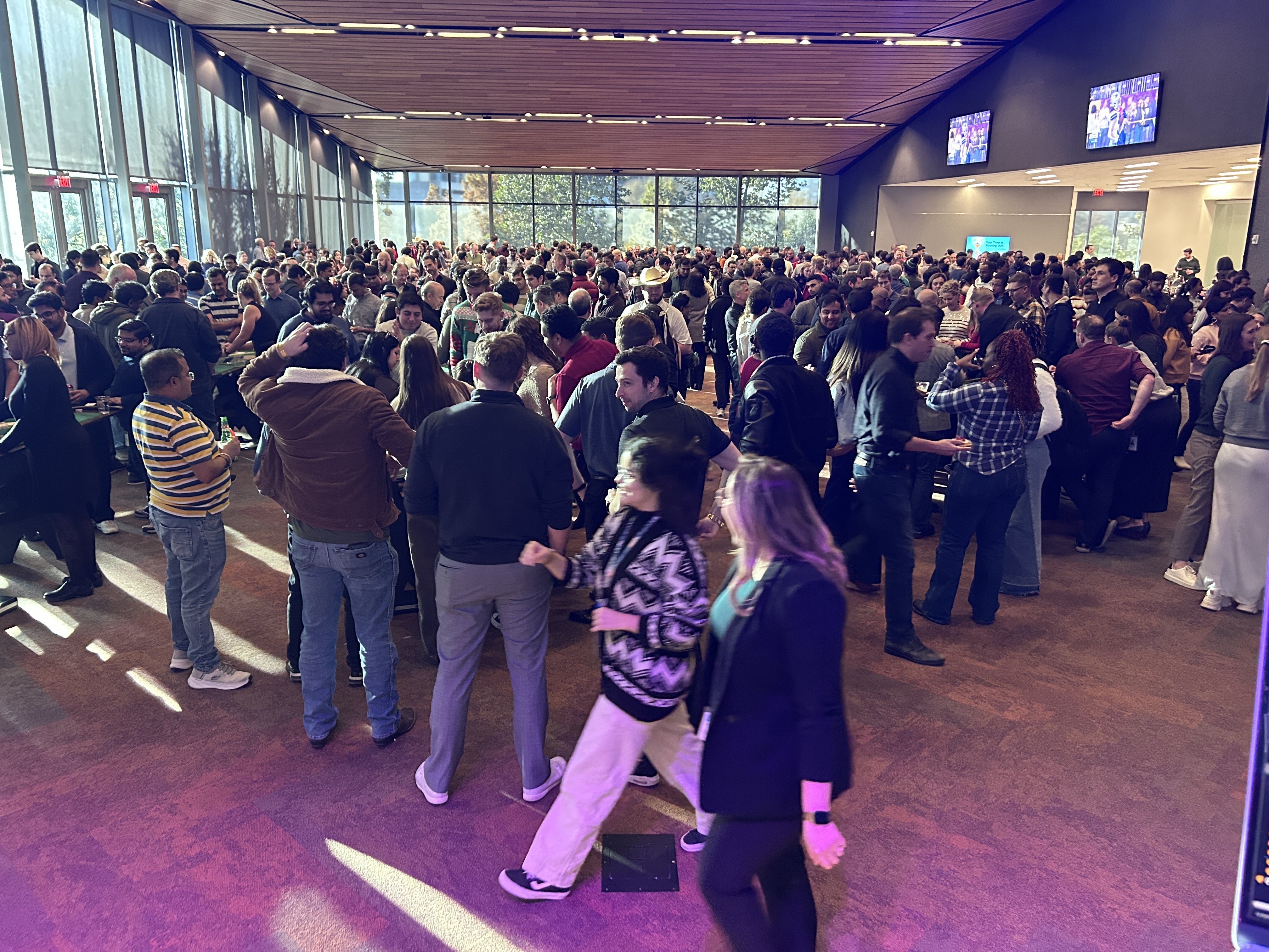 DJ on stage at corporate event with dancing guests