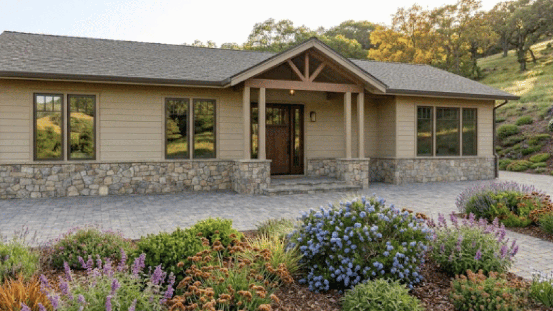 Detail of new fiber-cement siding, enclosed eaves, integrated ember-resistant vent, and stone base on a Lafayette home