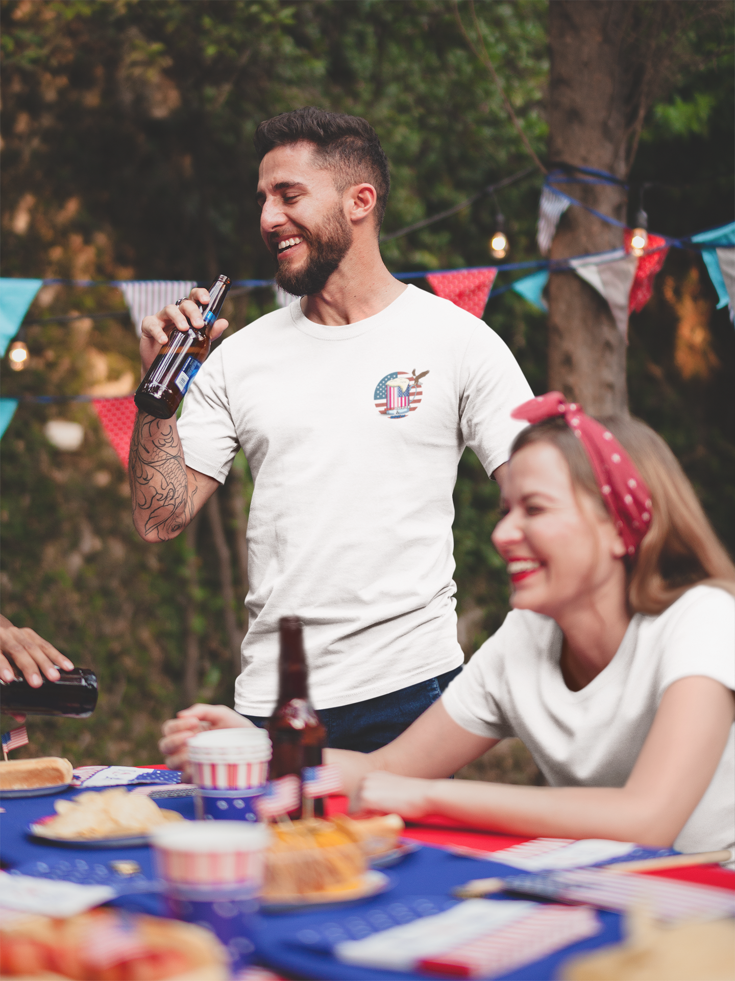 Two people drinking at a picnic table