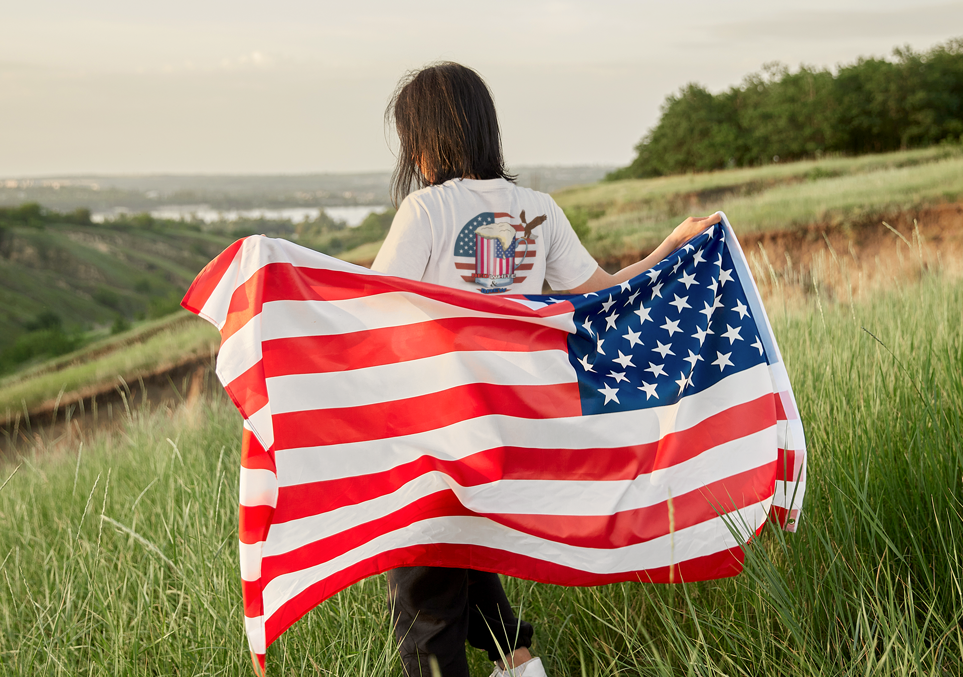 Woman holding an American flag behind her black