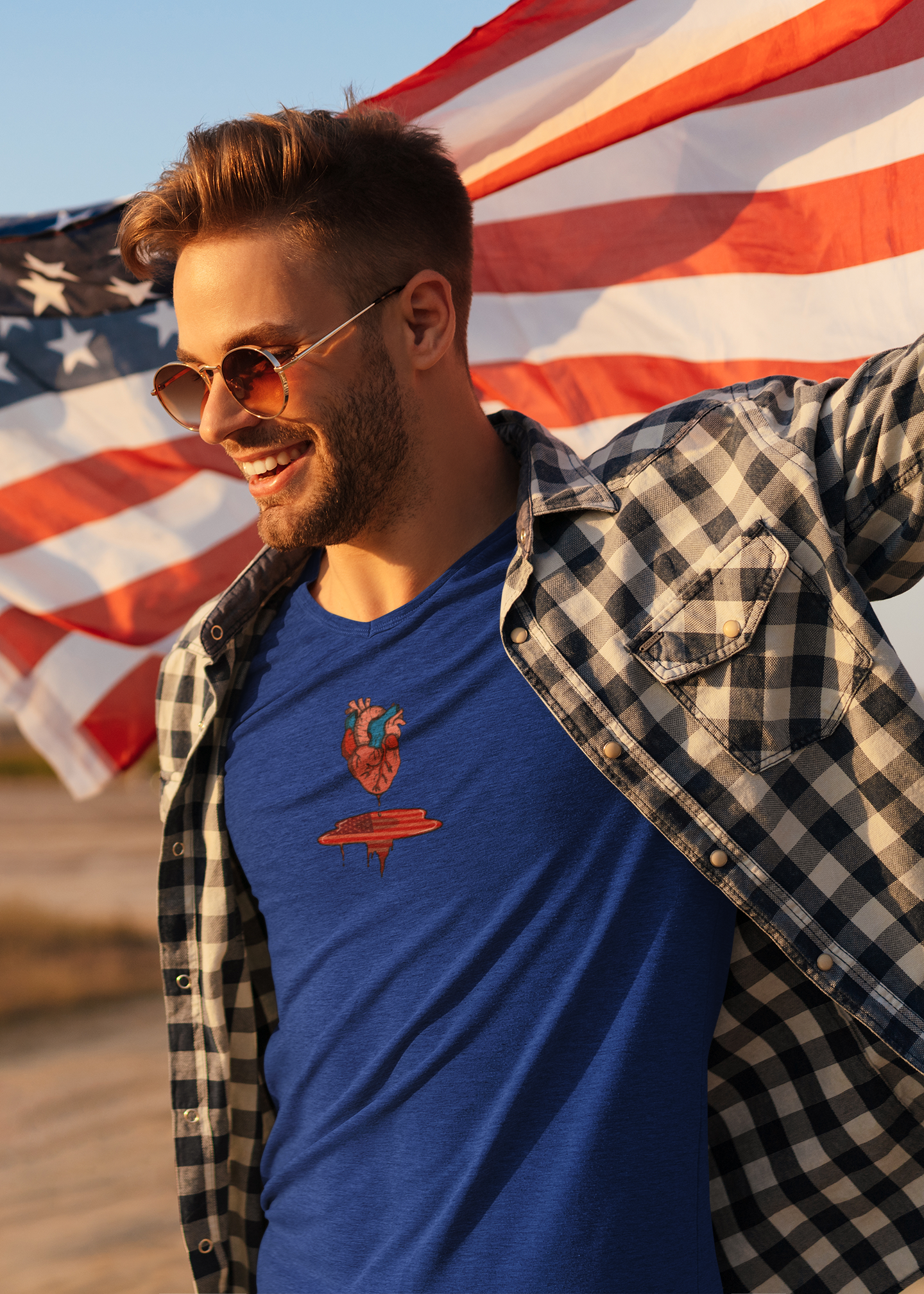 Man holding an american flag above his head