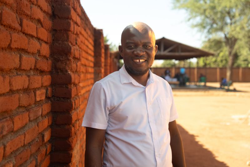 A school leader smiling