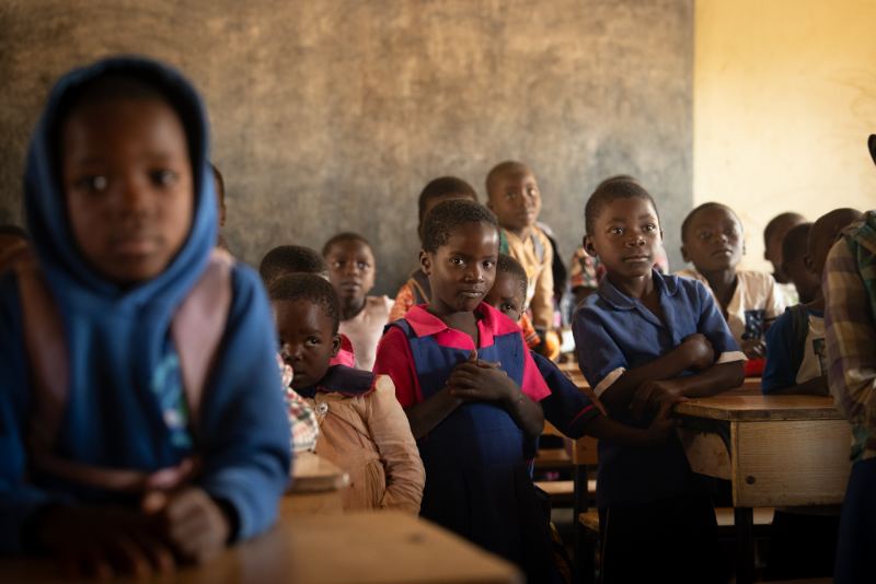 A girl in a blue hoodie in class