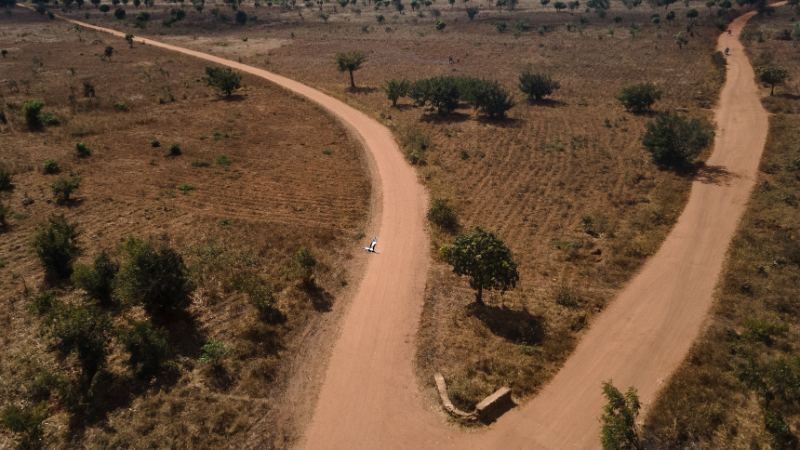 Red dirt road winding through Malawi from above