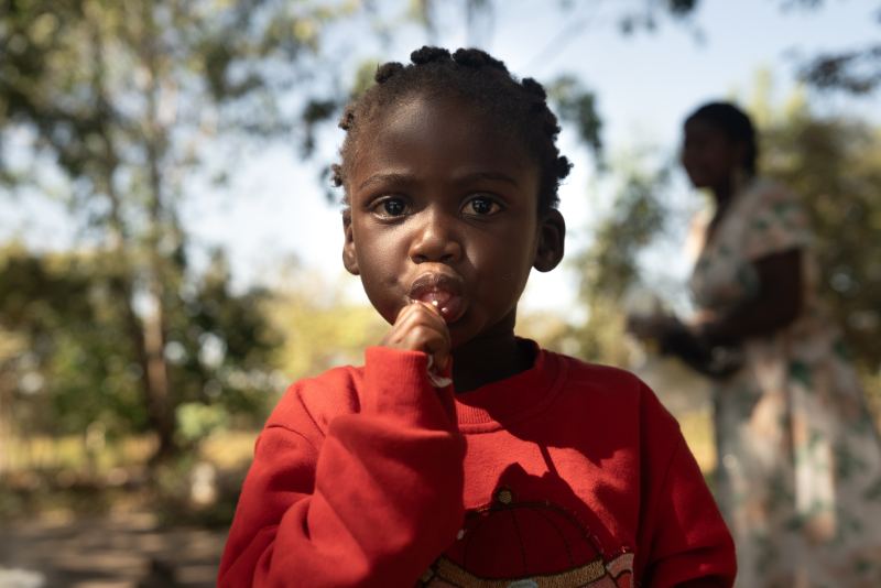 A young girl in a red shirt in Malawi