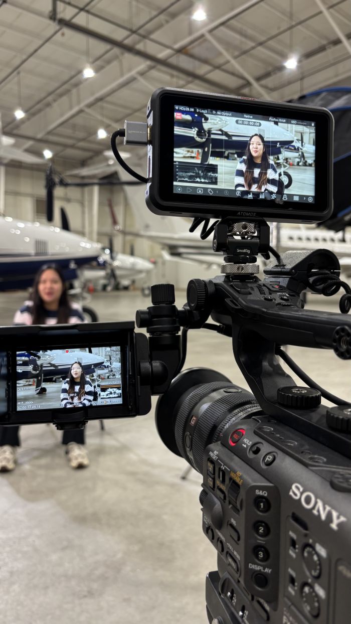 Cinema camera and monitors set up for an interview in an airplane hangar