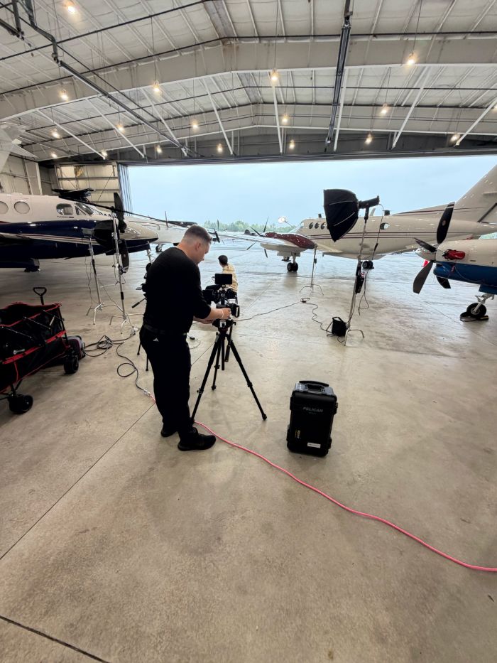 Full video production setup inside an airplane hangar