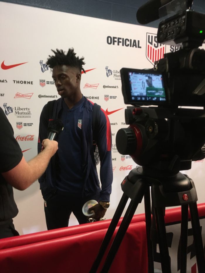 Filming a soccer player interview at a press event