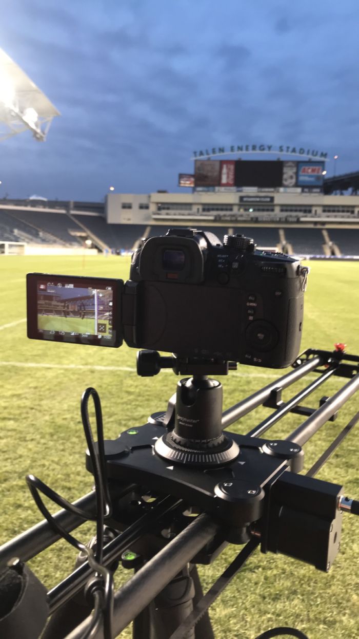 Camera on a slider filming at a soccer stadium