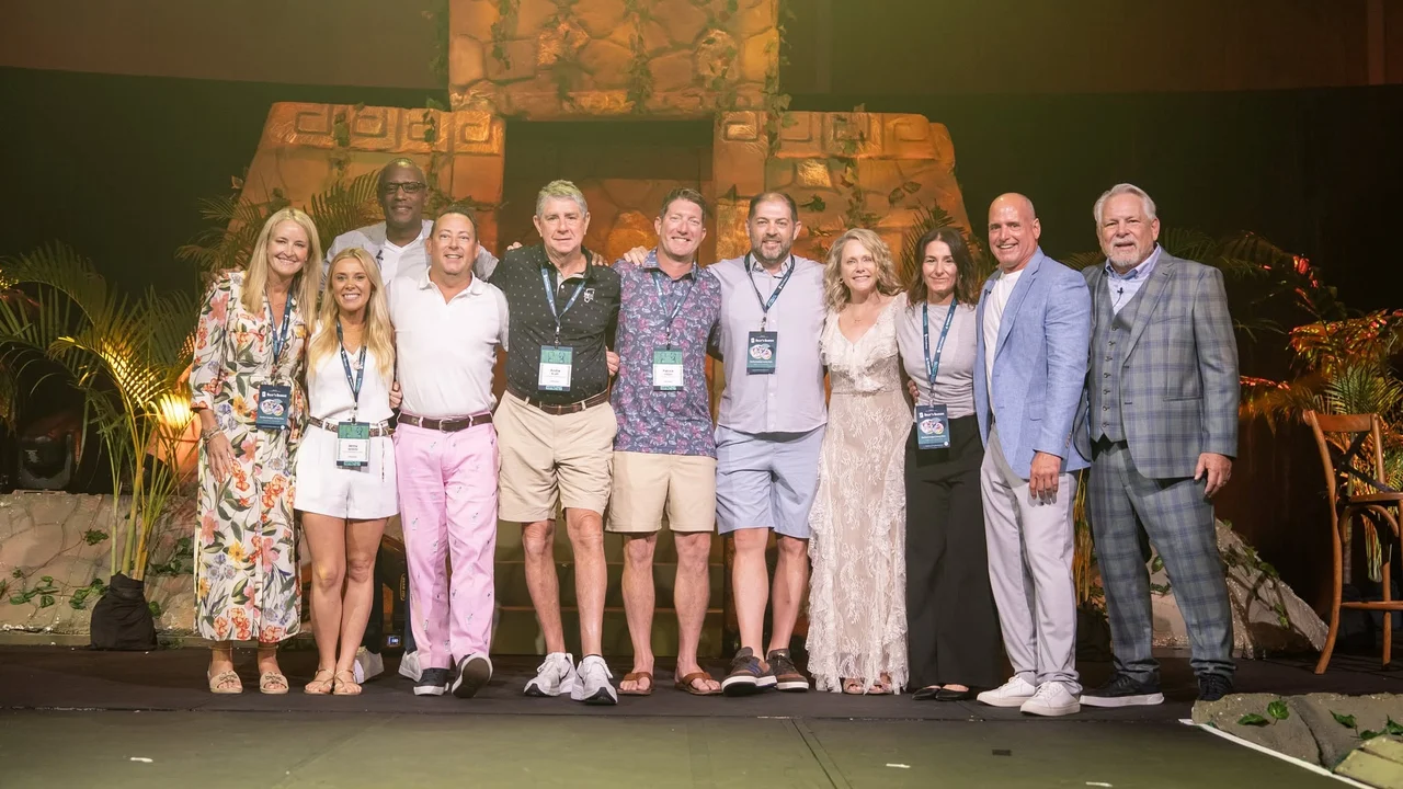 HPN Global associates and leadership together on stage, arm in arm