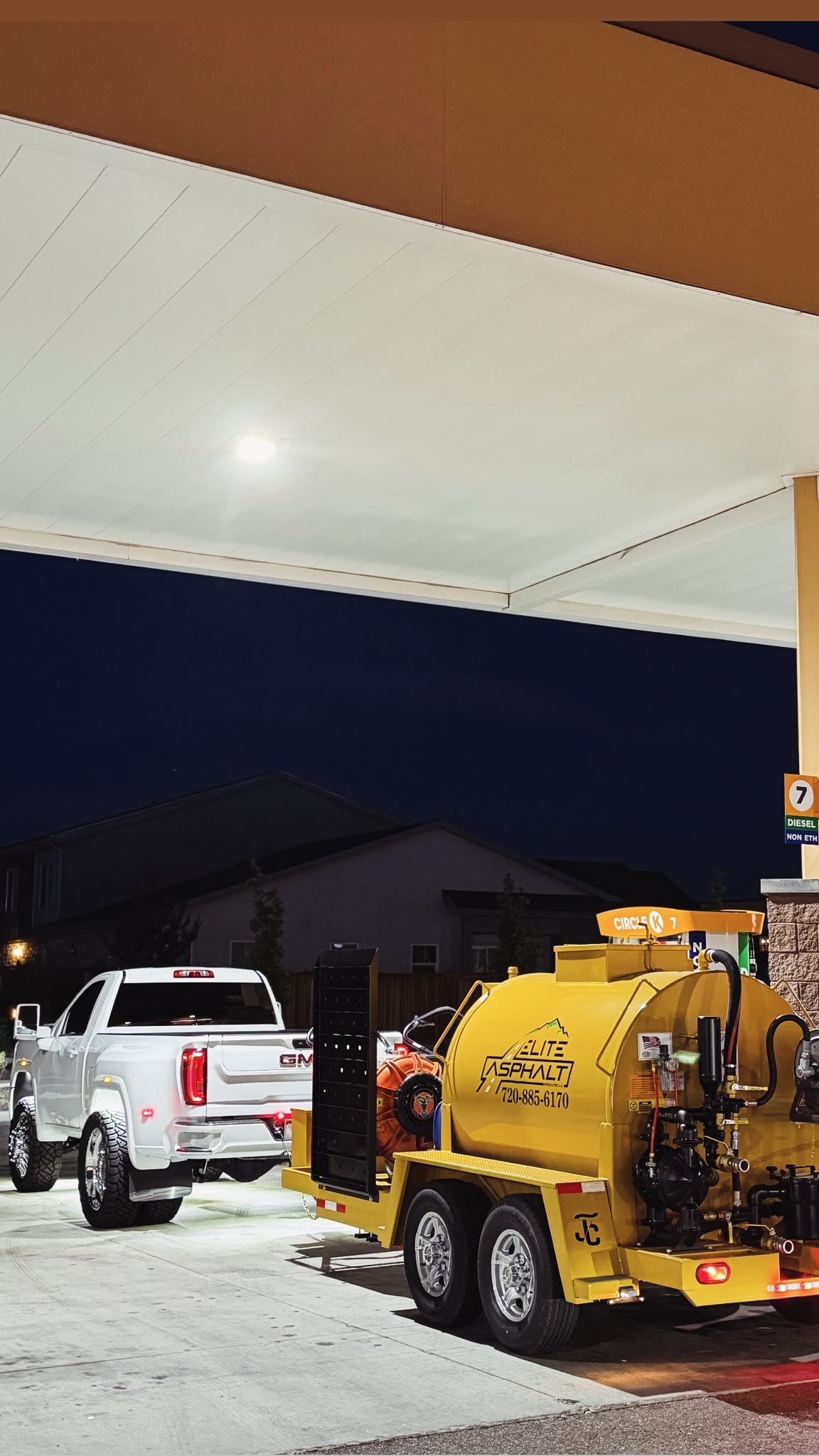Elite Asphalt Specialties work truck and yellow sealcoat tank trailer