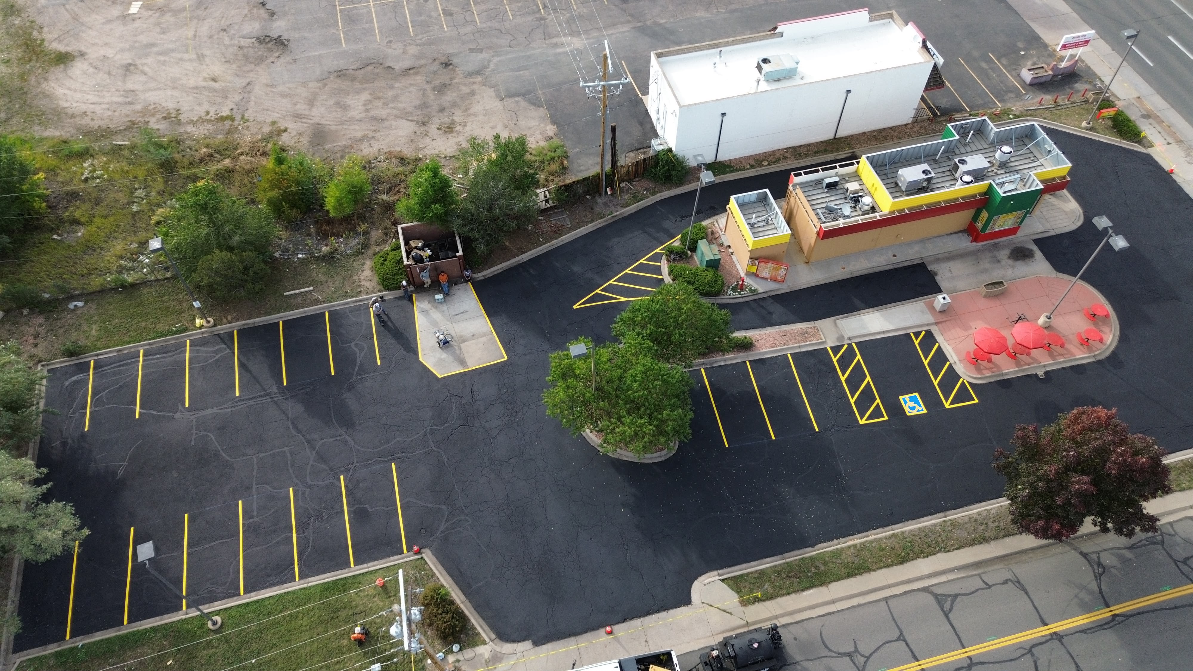 Restaurant parking lot with fresh crack fill, sealcoat and new striping