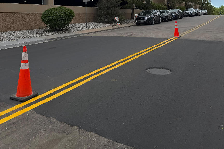 Asphalt patch with fresh double yellow center lines