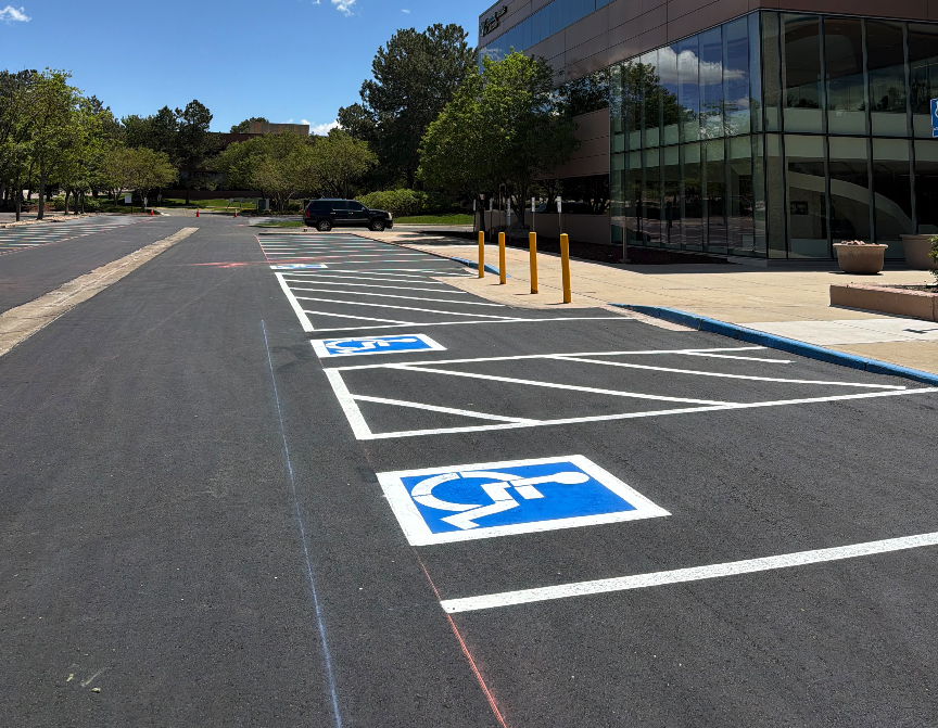Brand new asphalt with two freshly striped handicap stalls