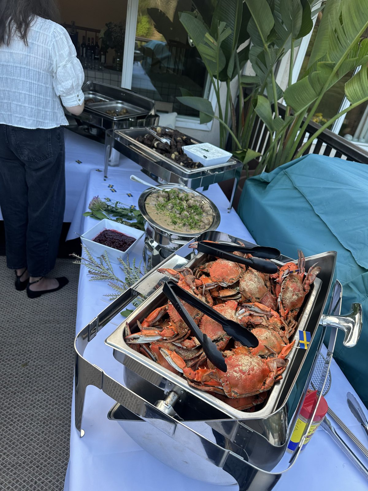 Outdoor patio buffet with whole crabs, Swedish meatballs and lingonberry at a private party