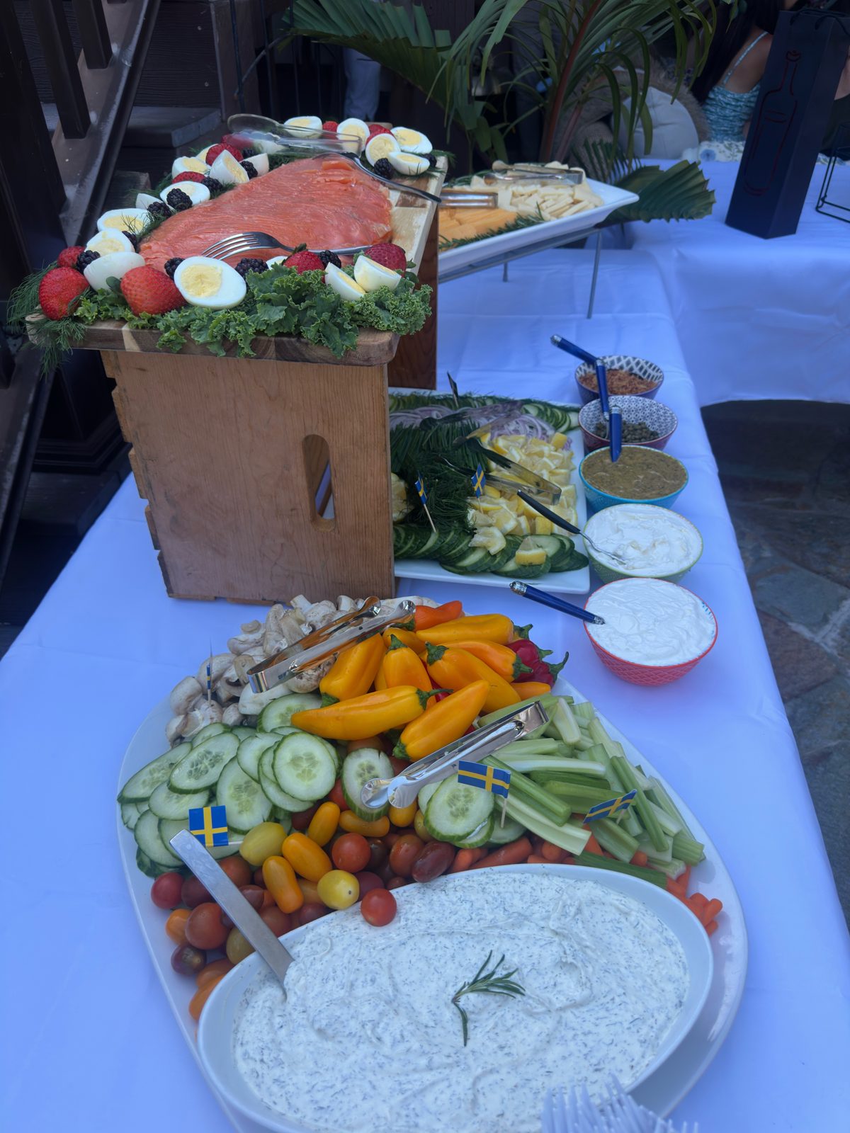 Appetizer spread with smoked salmon, deviled eggs, fresh vegetables and dips