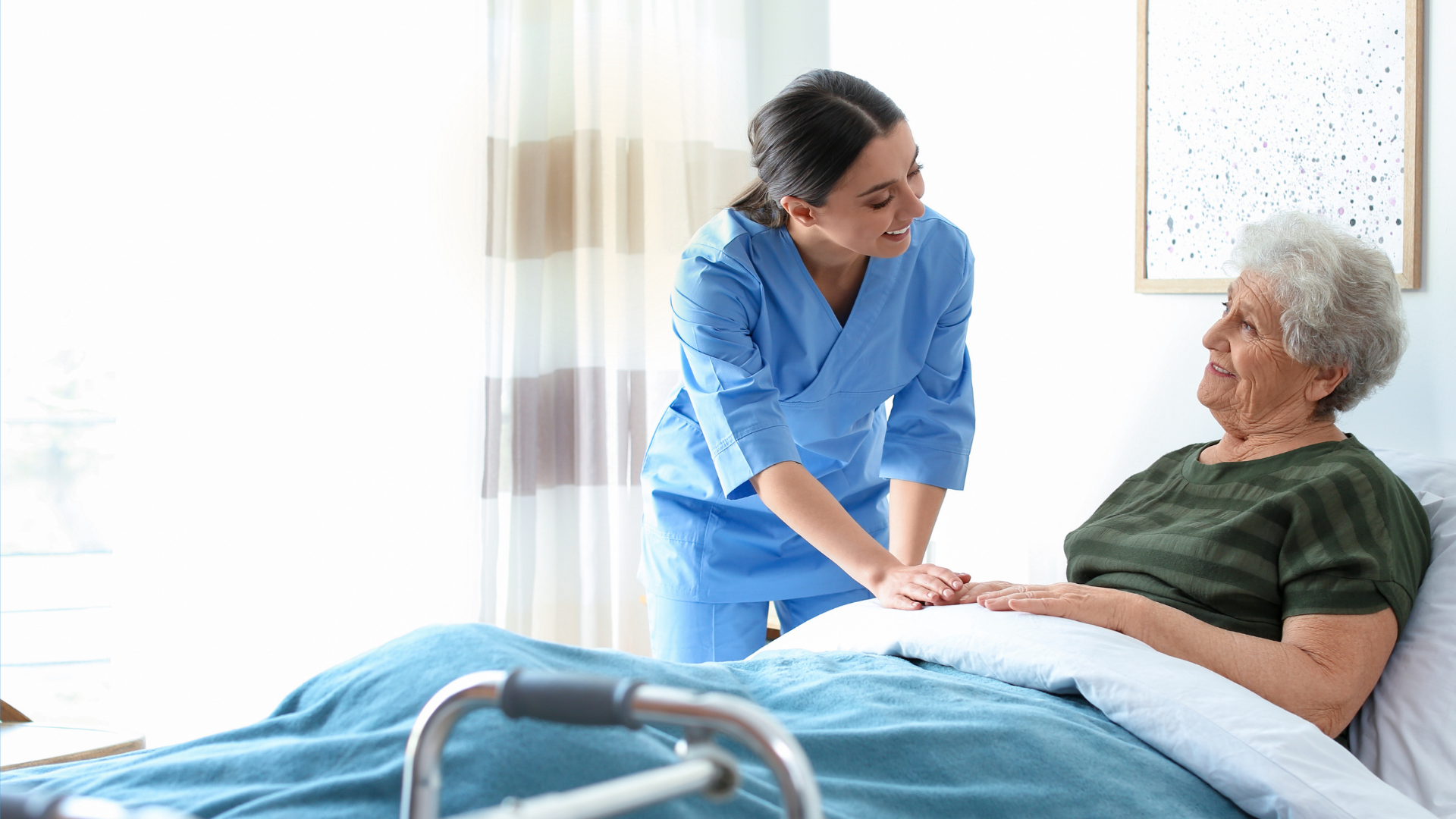 A nurse holding hands with an older woman at home while a child plays nearby