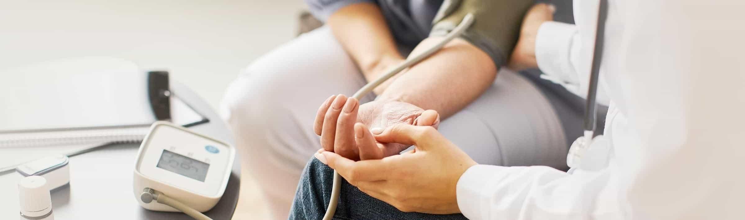DOCTOR-CHECKING-BLOOD-PRESSURE