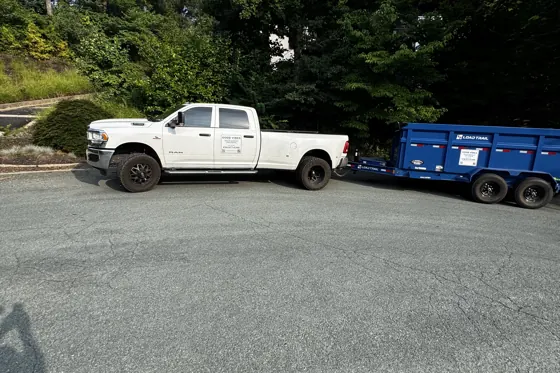 Good Vibes truck and dump trailer on a residential driveway in Charlottesville VA