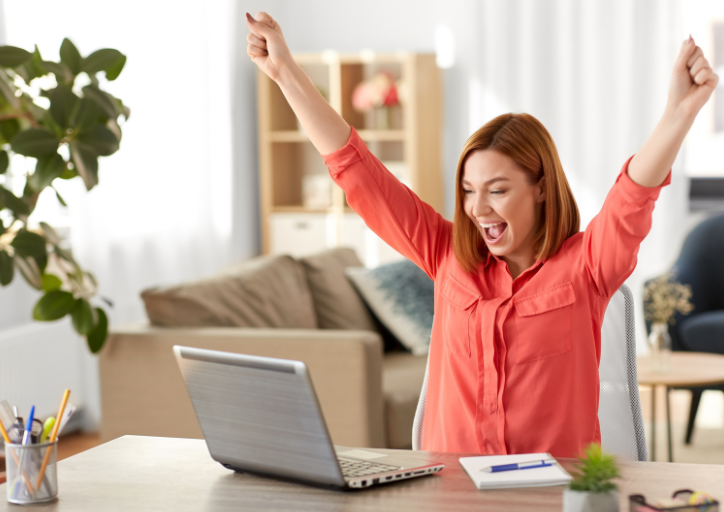 A woman celebrating because she is no longer wondering why do I keep things I don’t need anymore