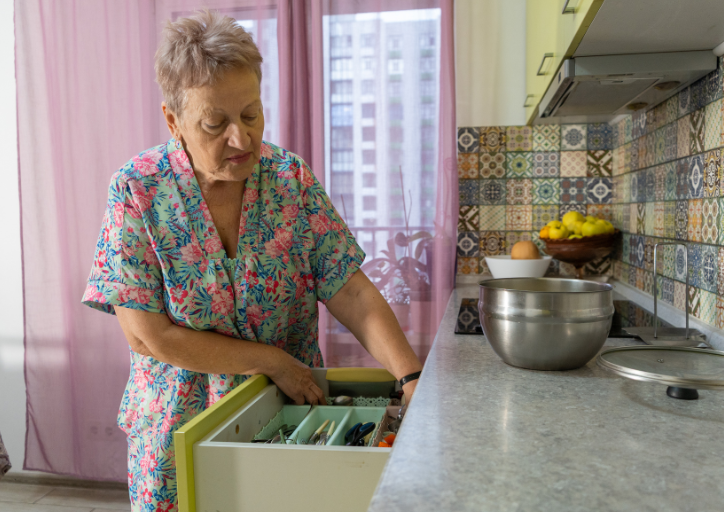 A woman looking into a drawer wondering why do I keep things I don’t need anymore