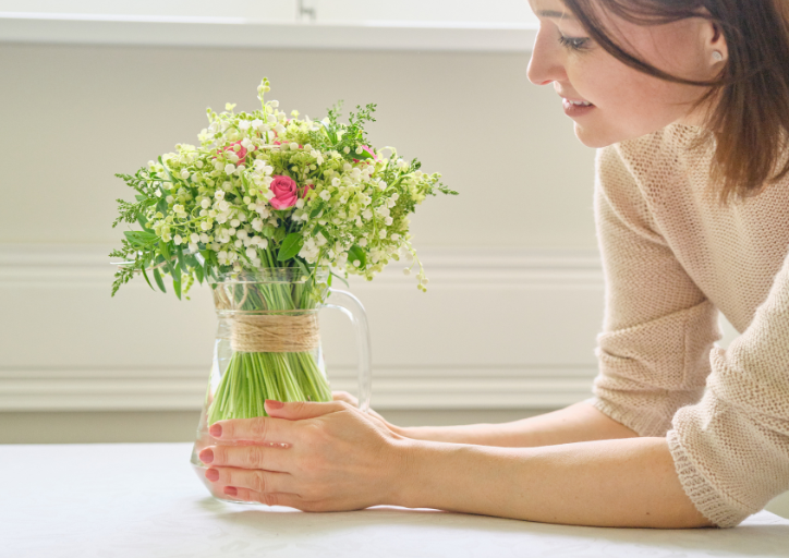 Woman holding onto a vase thinking why do I keep things I don’t need anymore