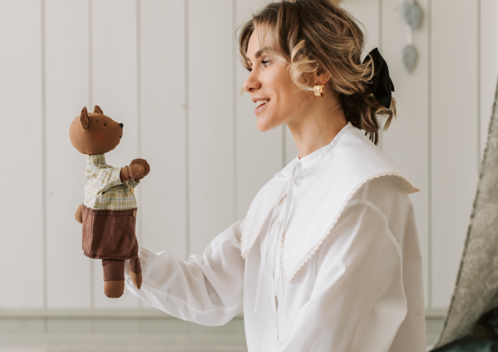 Woman holding a toy asking herself why do I keep things I don’t need anymore