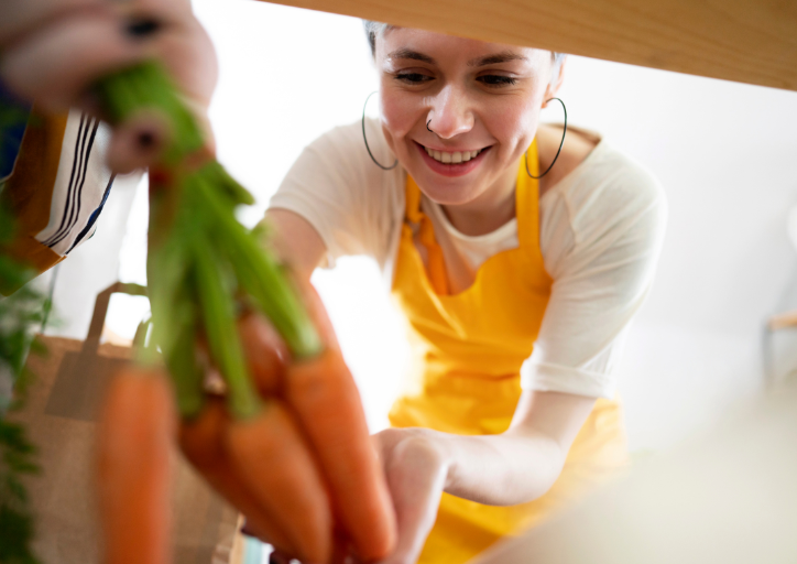 Woman smiling as she organizes her kitchen pantry. Woman smiling as she organizes her kitchen pantry.