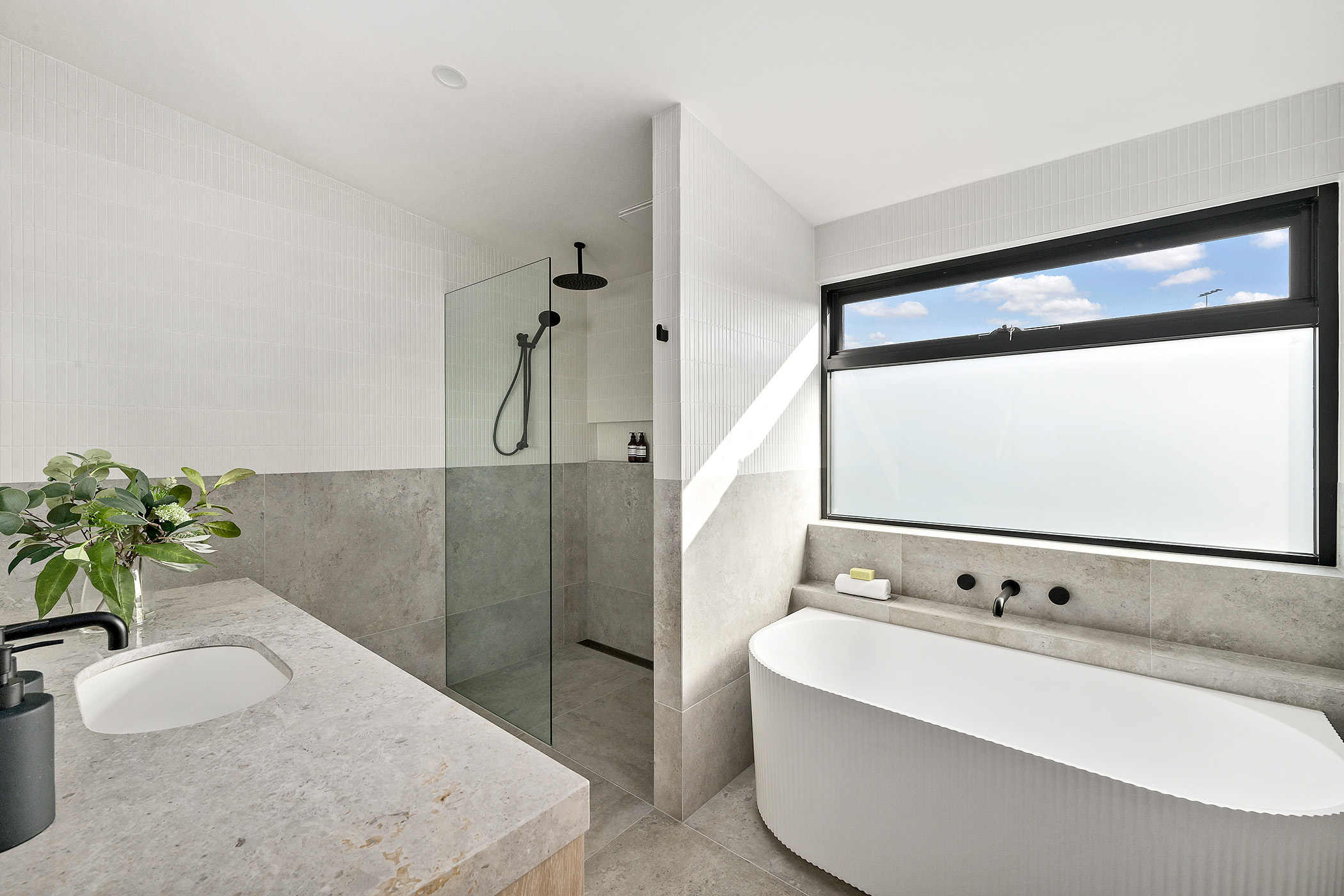 Modern family bathroom with custom vanity and lighting