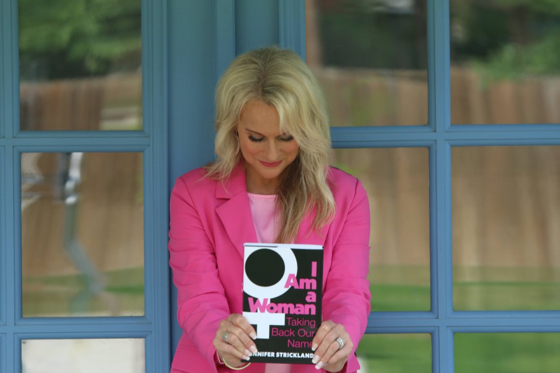 Jennifer Strickland holding I Am a Woman