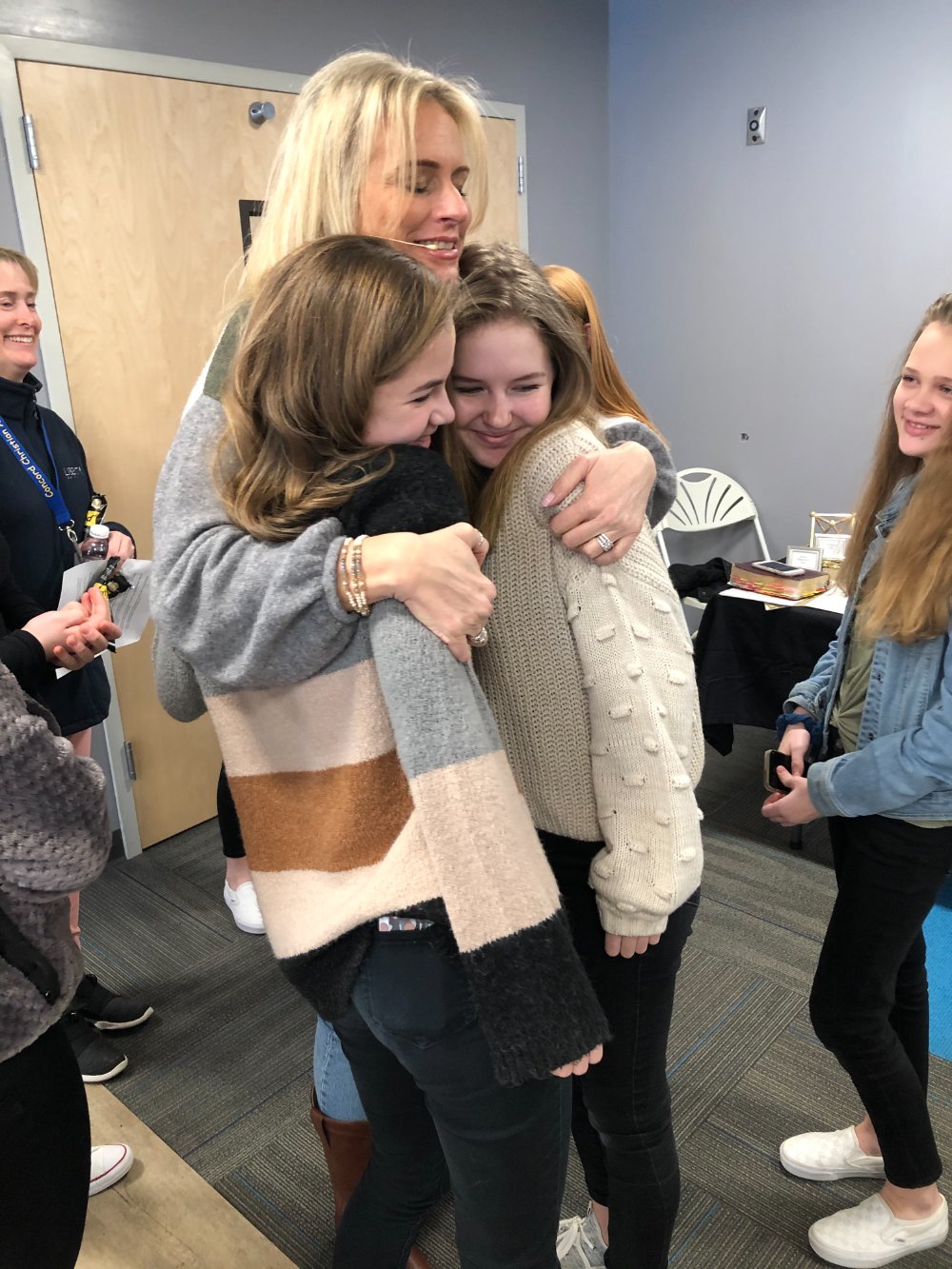 Jennifer embracing young women after speaking