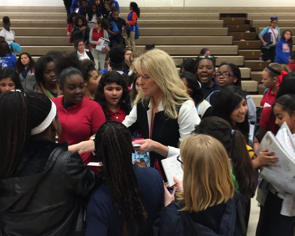 Jennifer signing books among students