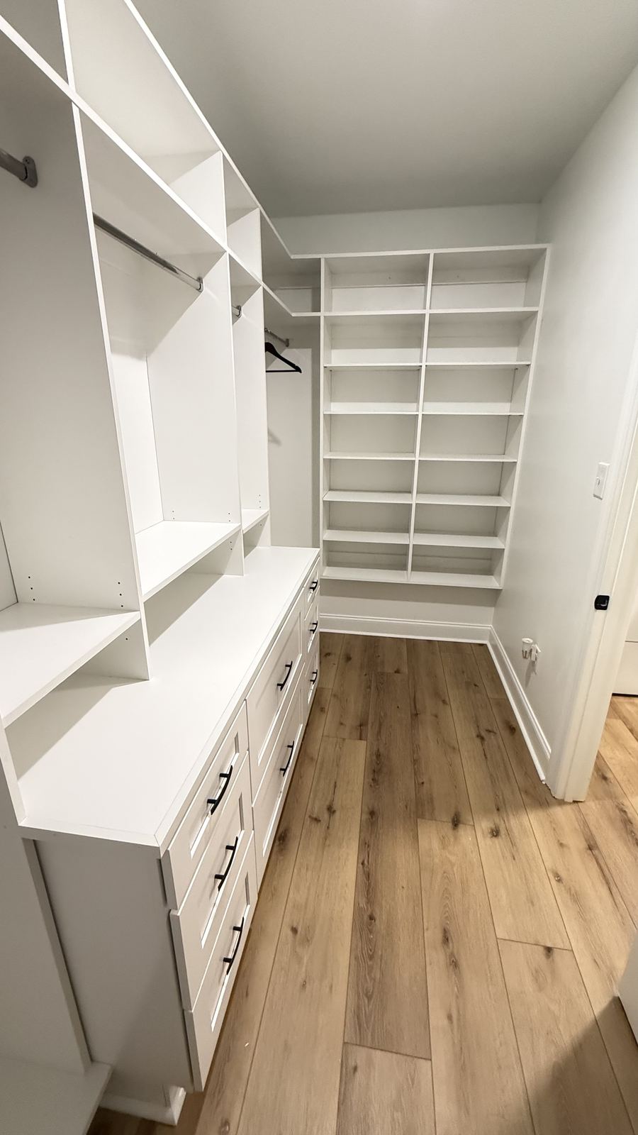 White custom walk-in closet with drawers and shelving