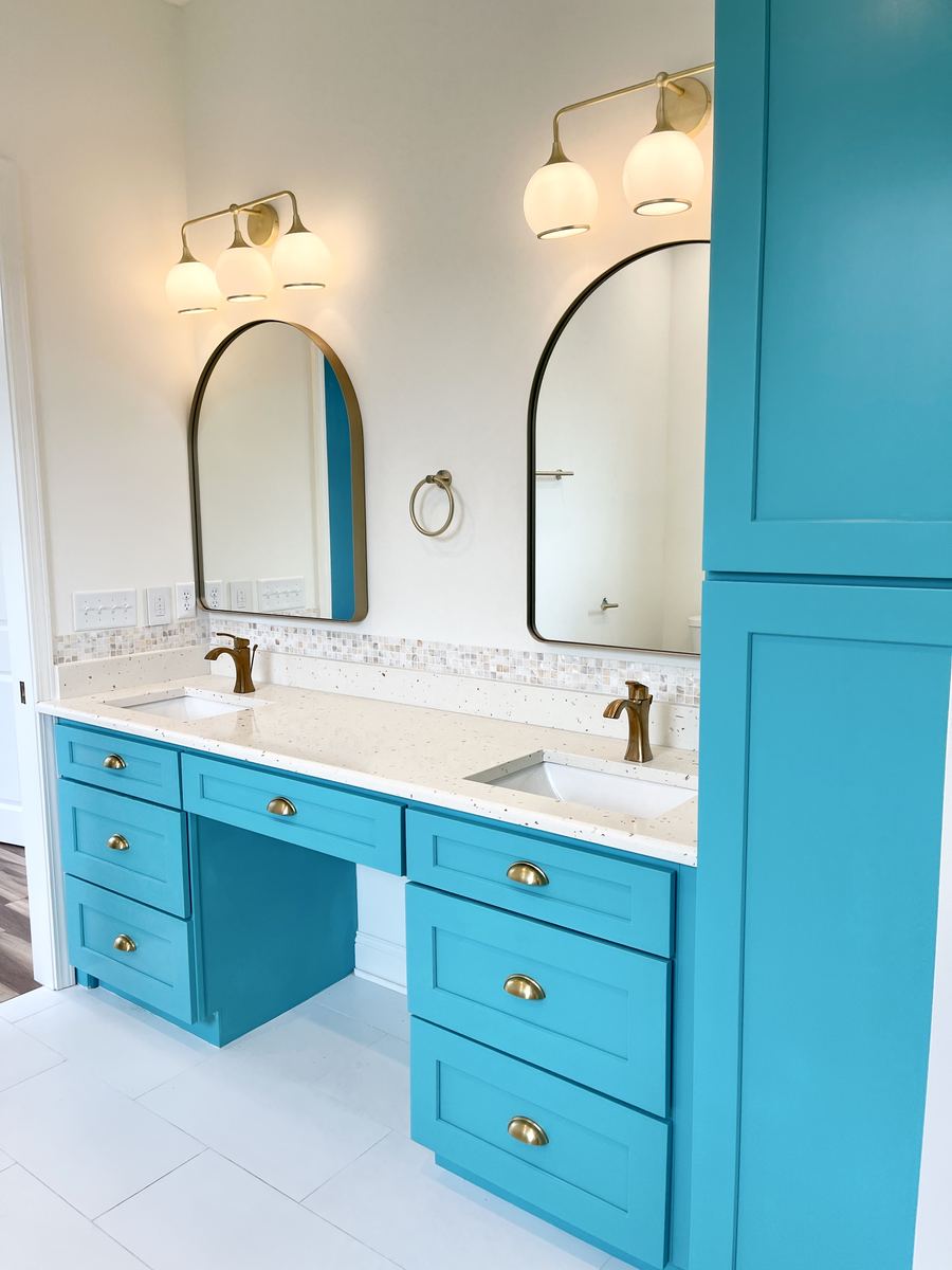 Custom teal double vanity with makeup station