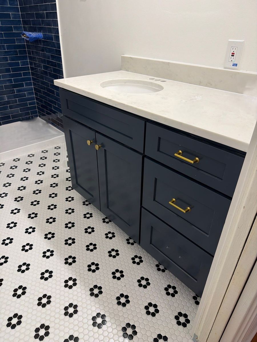 Navy shaker bathroom vanity with brass pulls