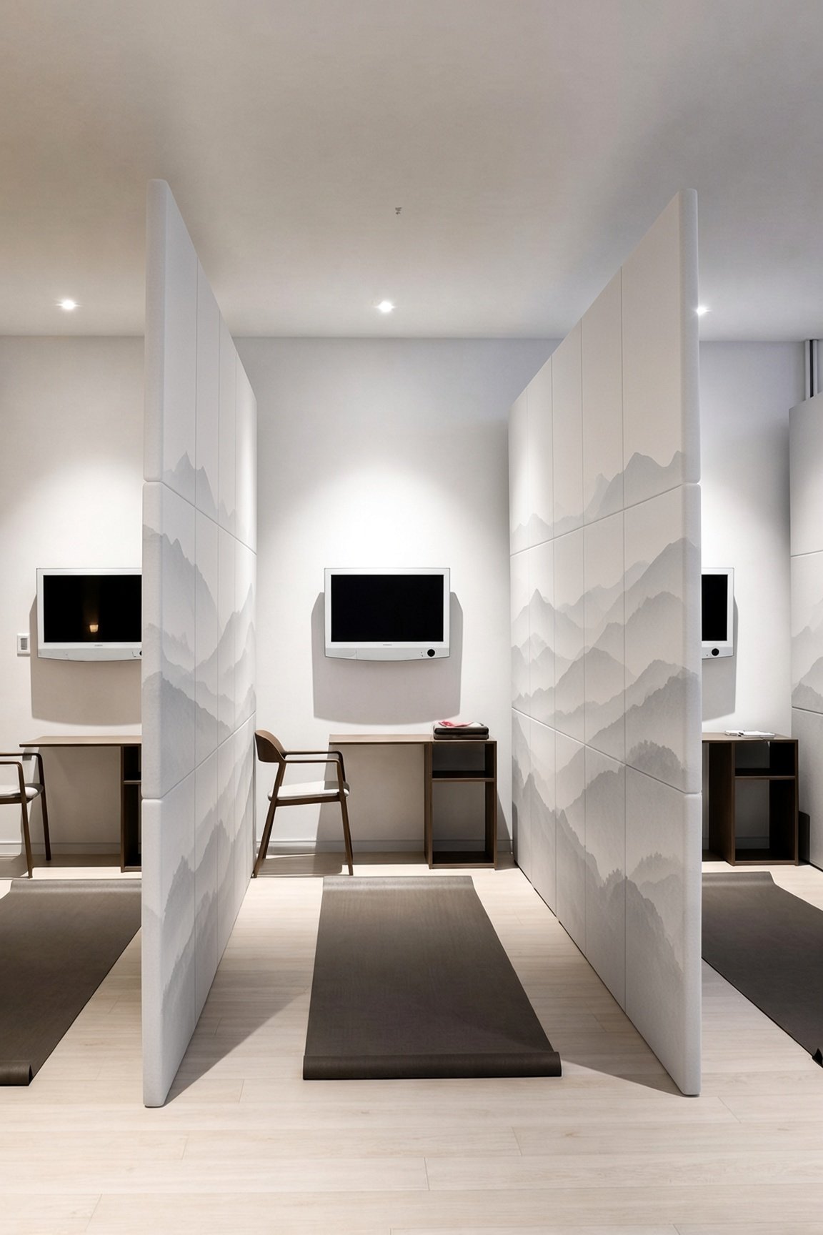 Sunon wellness room with acoustic dividers printed with misty mountains, yoga mats and small desks