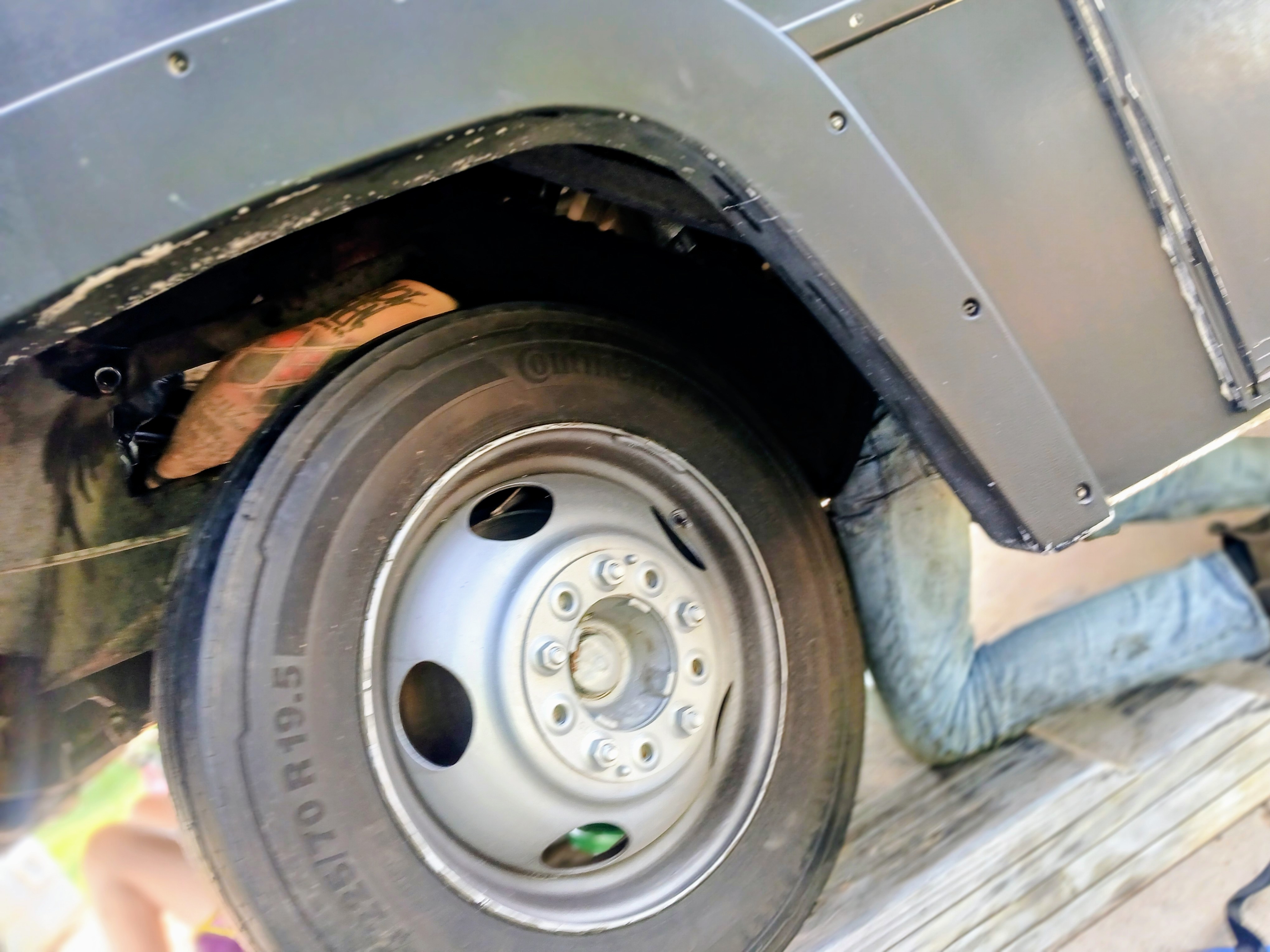 Joe Davenport performing mobile under-vehicle repair on a work van in Bastrop County, TX