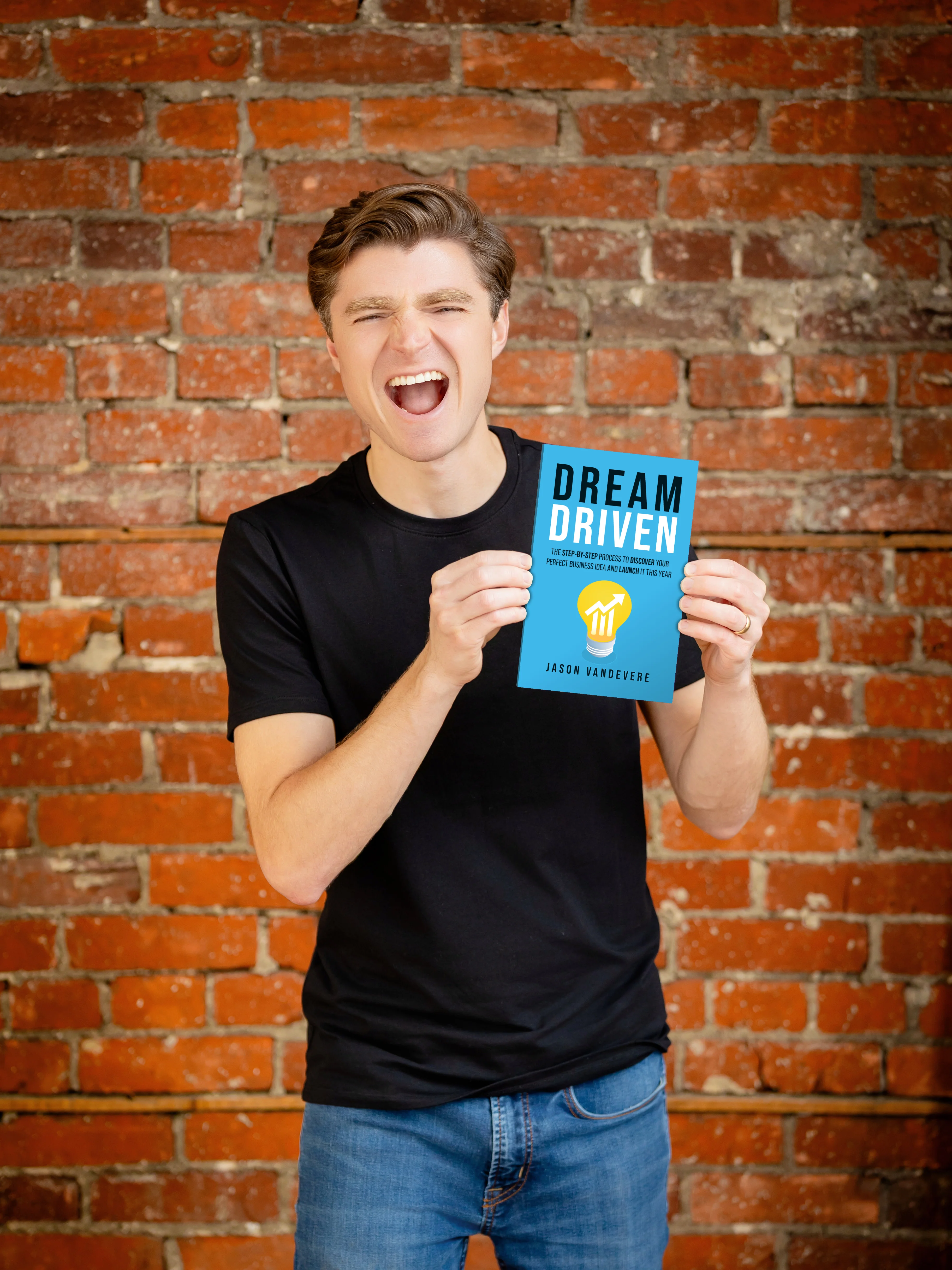 Jason VanDevere holding his book Dream Driven