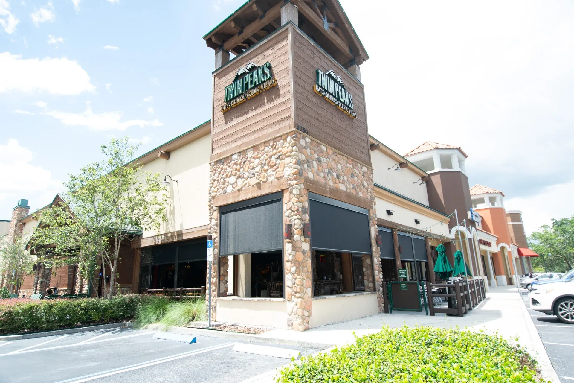 Go-Fenetex hurricane-rated storm screens on commercial restaurant exterior – retractable patio screen weather protection