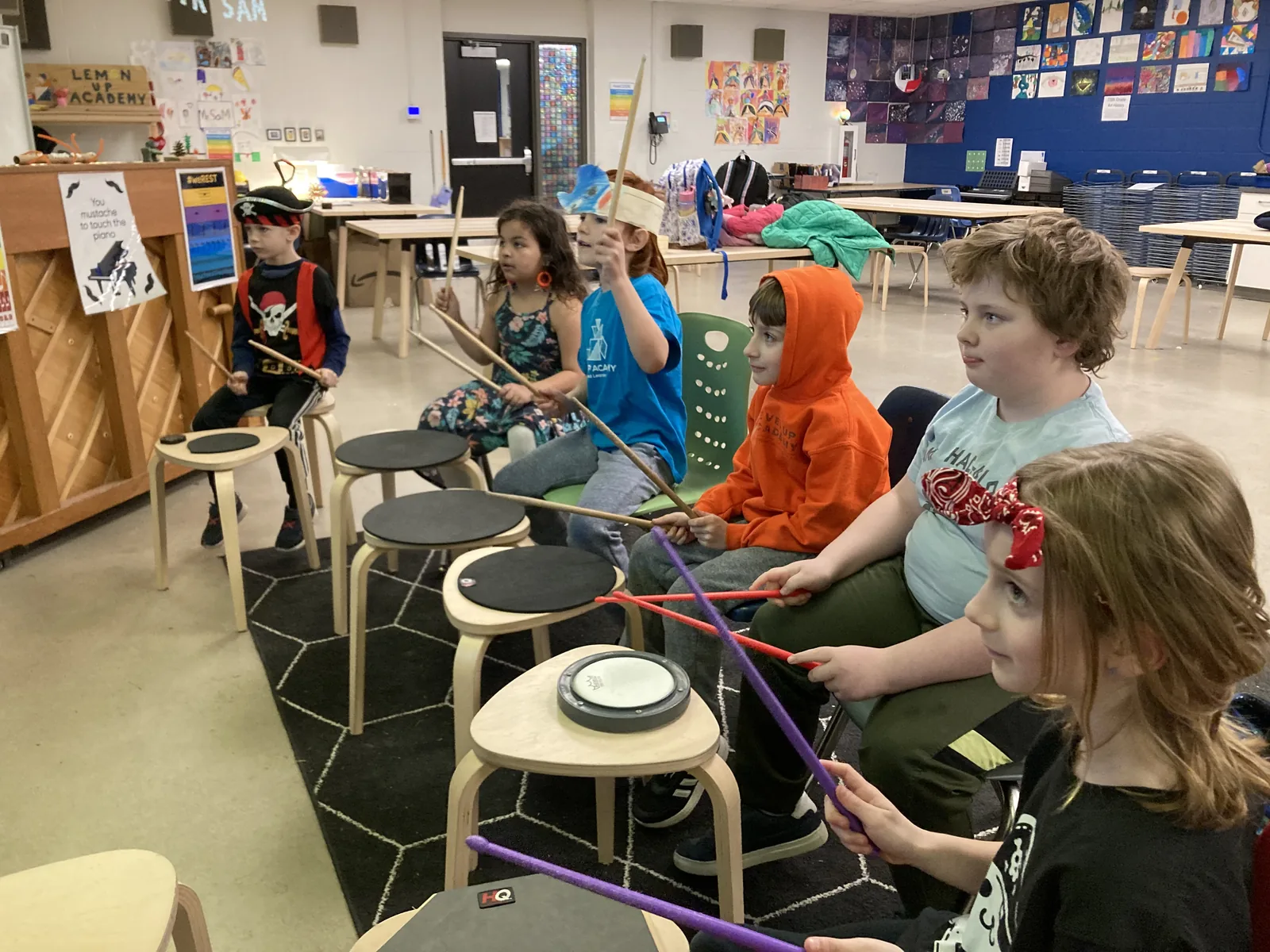 Students participating together in a music classroom activity.