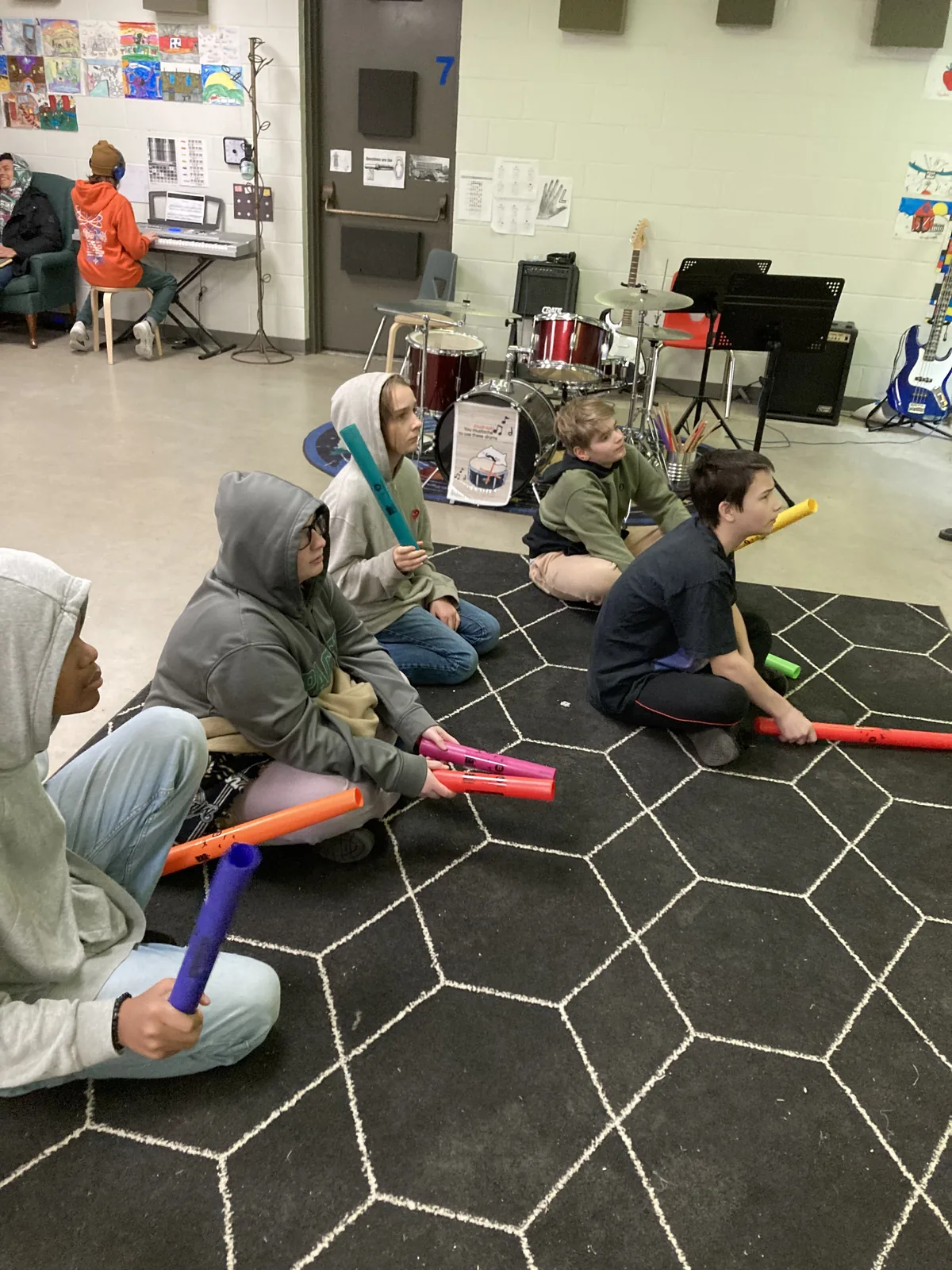 A student playing an instrument in the music classroom.