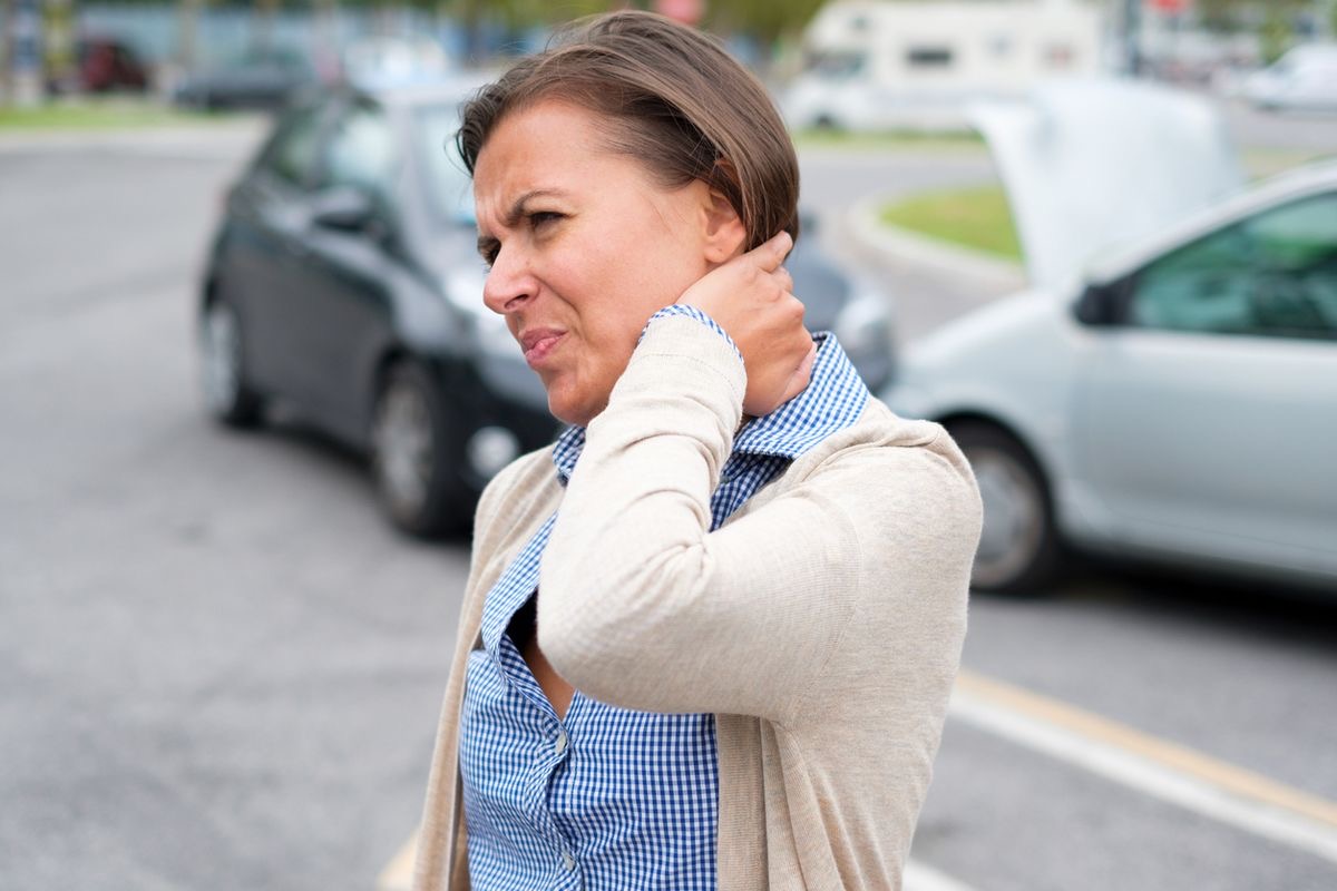 Woman holding her neck after a car accident