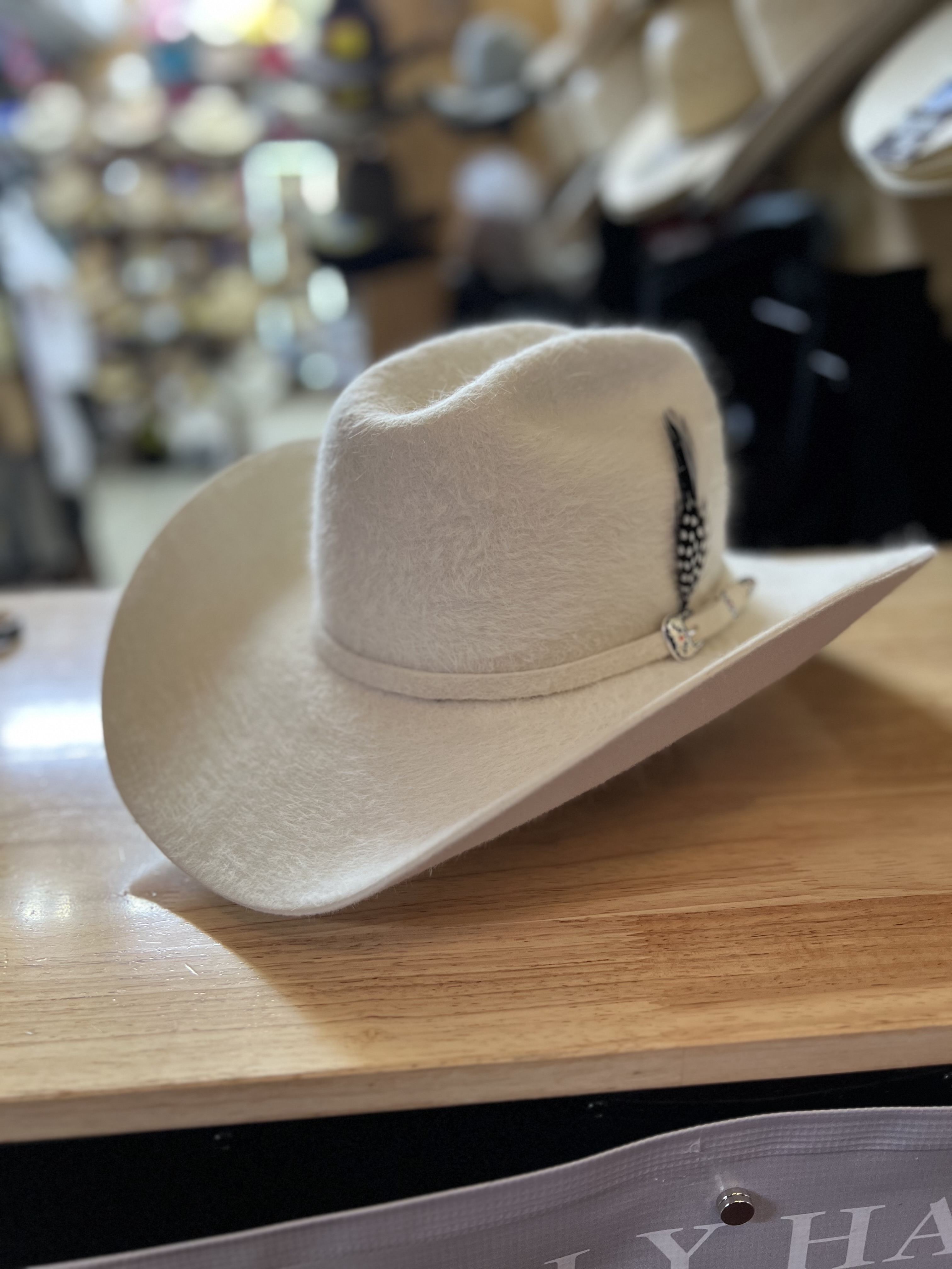 Custom cream cowboy hat with feather band
