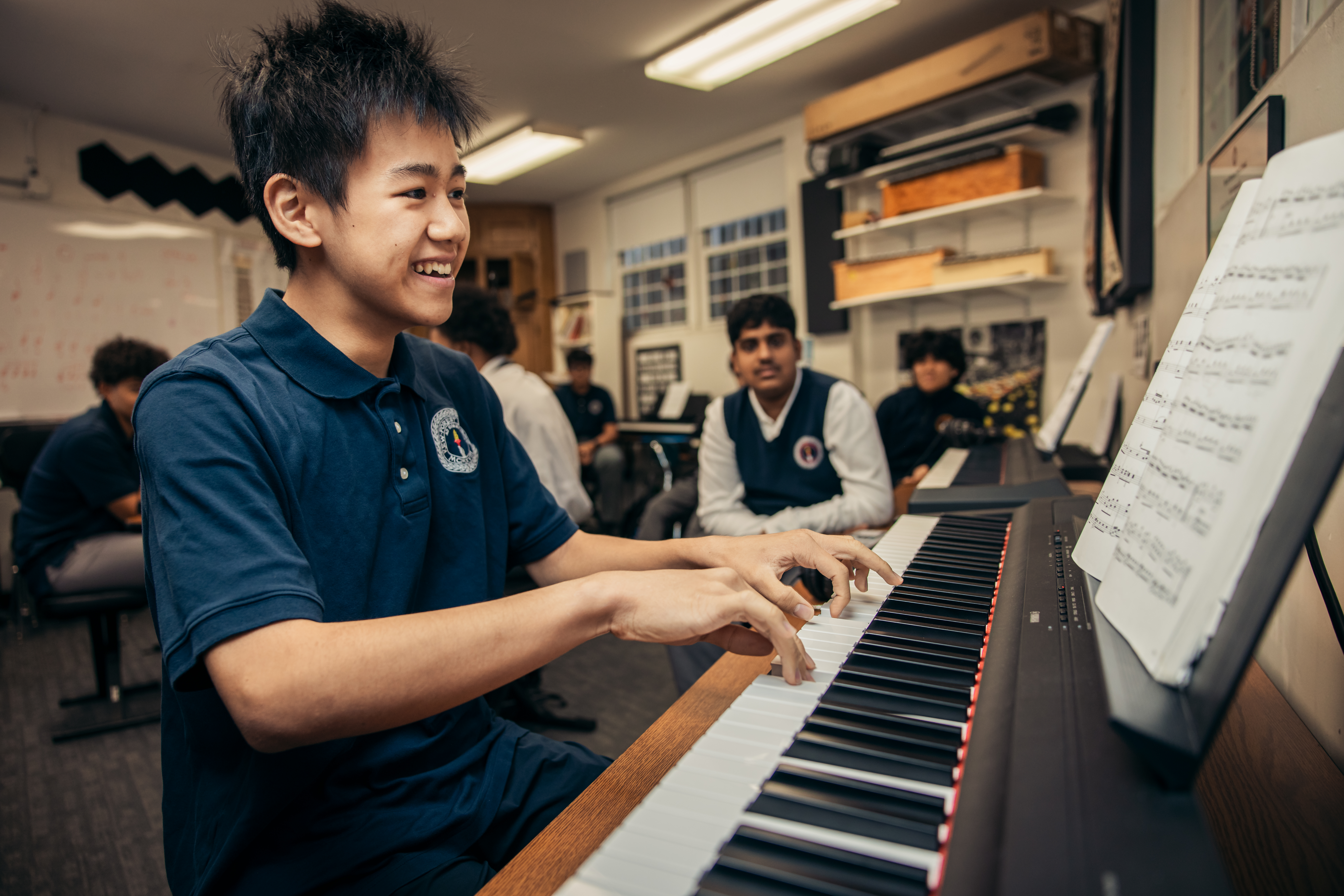 Student playing piano in music class
