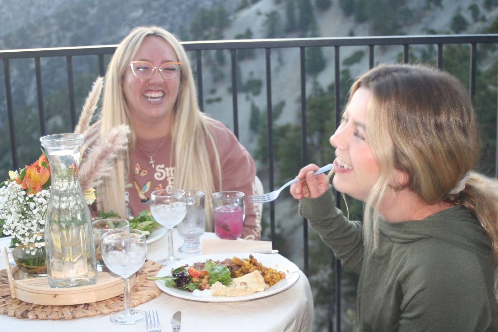 Guests laughing over dinner