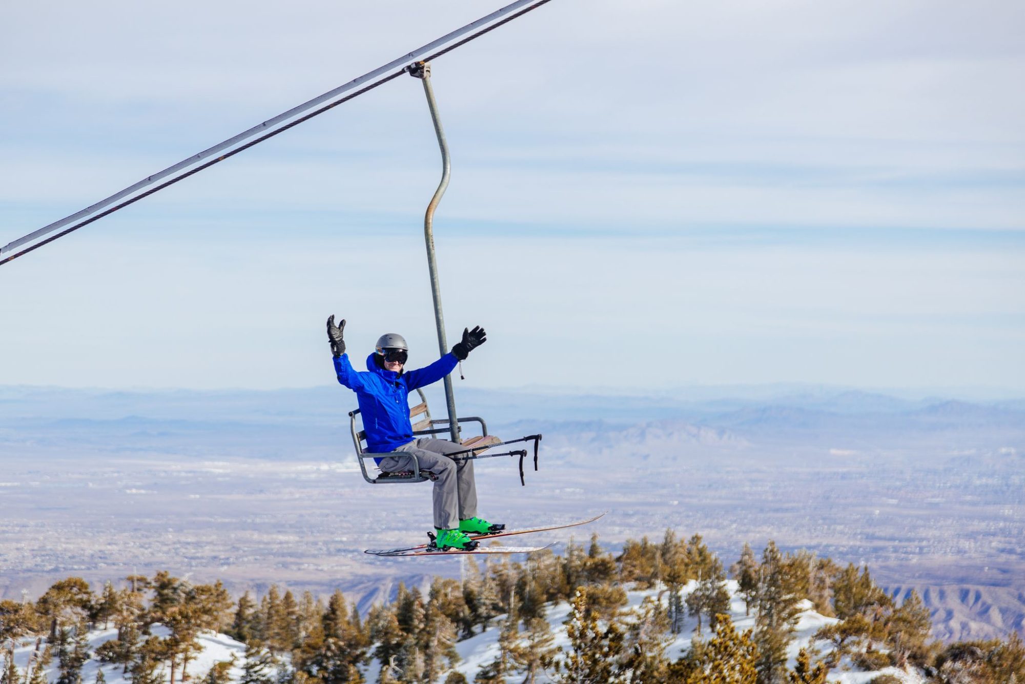 A rider on the chairlift above the clouds